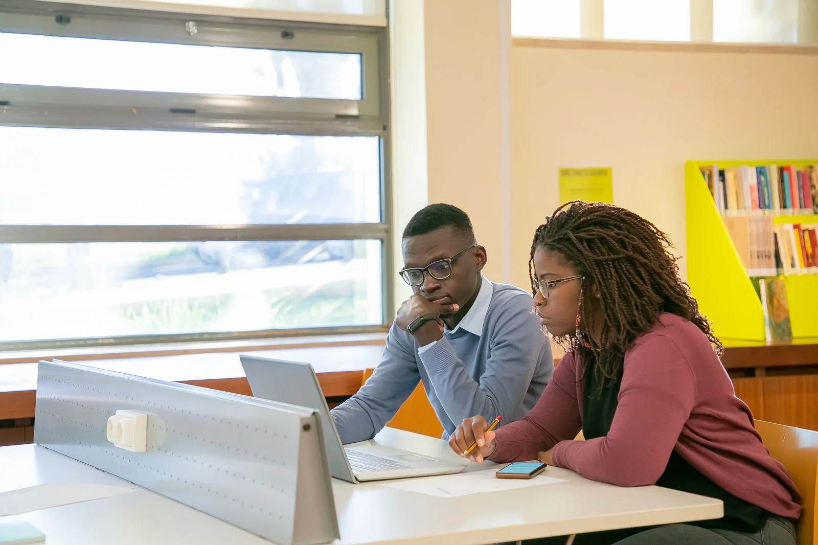 Black university students studying together in a library